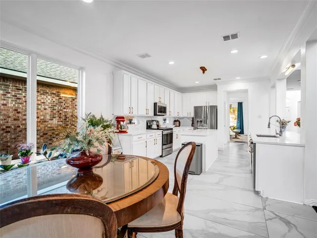 a view of a dining room with furniture and window