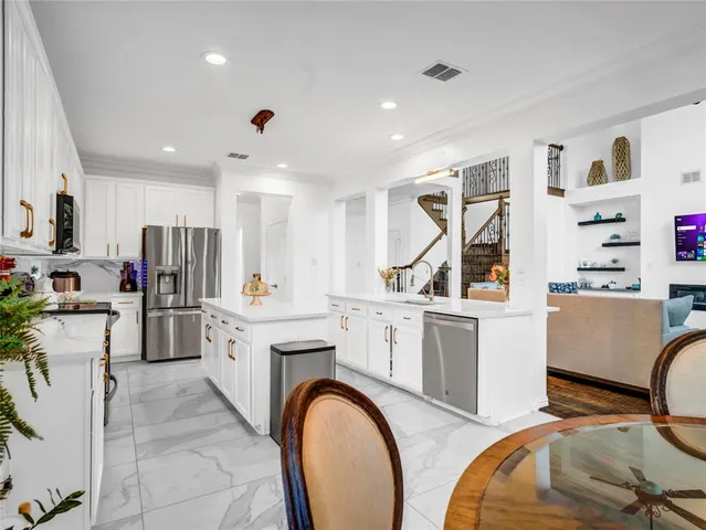 a dining room with furniture and potted plants