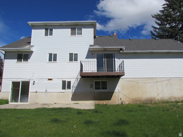 3166 Linden Street Bountiful, UT 84010 - Photo 25 of 25 Back of property featuring a patio, balcony, a shingled roof, a lawn, and a chimney