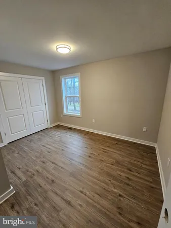a view of an empty room with a kitchen