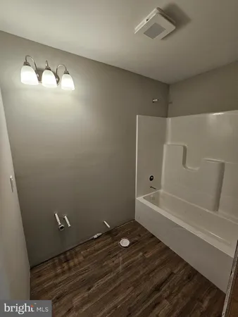 a kitchen with stainless steel appliances granite countertop a stove top oven a sink and a refrigerator