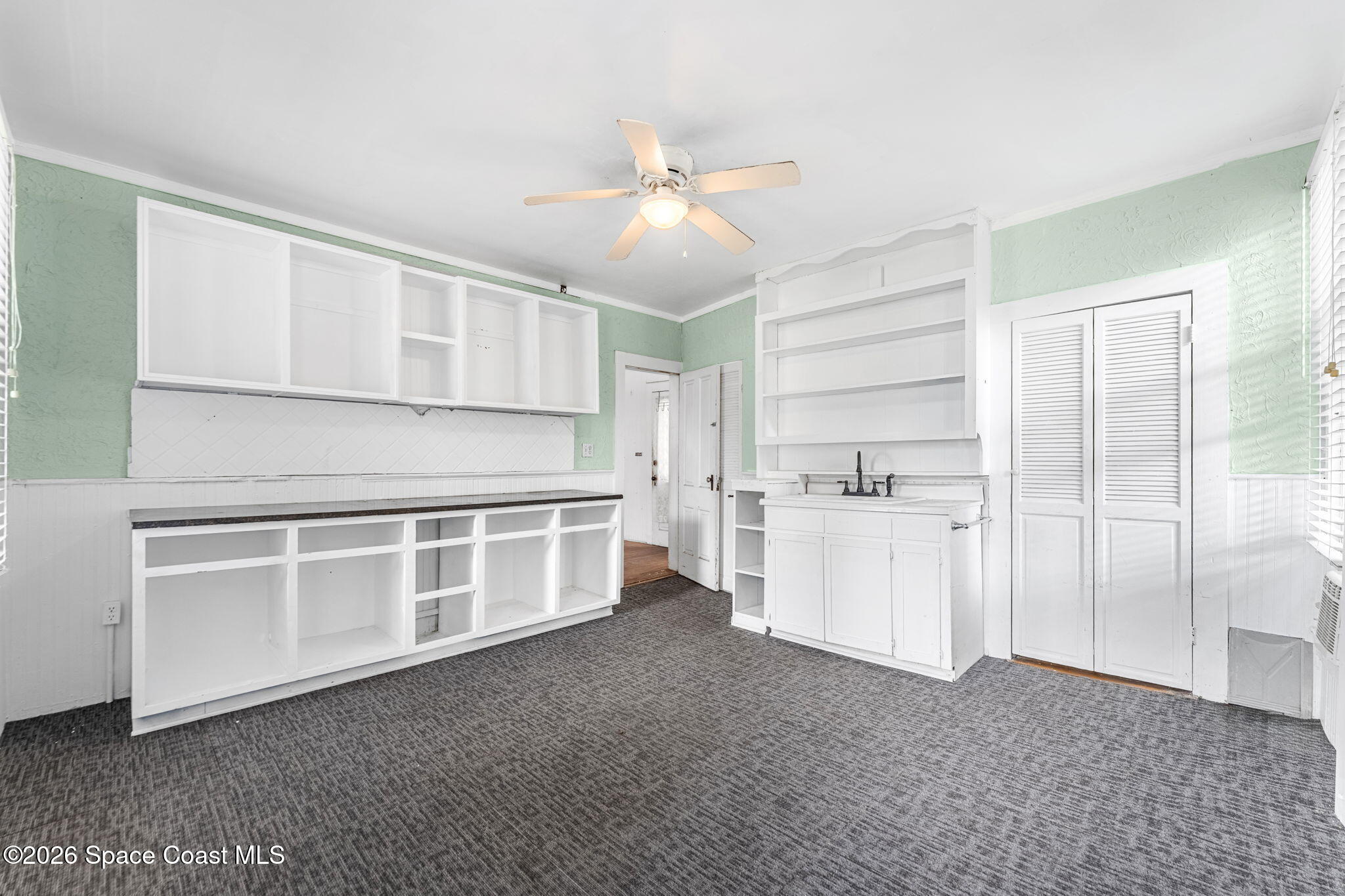 1101 Rockledge Drive Rockledge, FL 32955 - Photo 25 of 76 a kitchen with white cabinets and white appliances