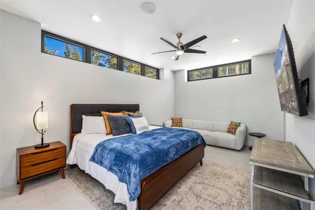 a bedroom with a large bed and a tv