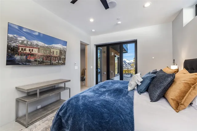 a bedroom with a bed and a painting on the wall