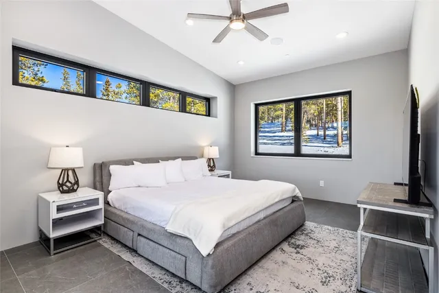 a bedroom with a bed and a painting on the wall