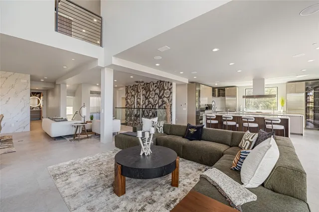 a kitchen with stainless steel appliances granite countertop a sink a stove and a refrigerator