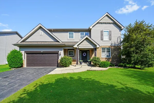 a front view of a house with a yard and garage