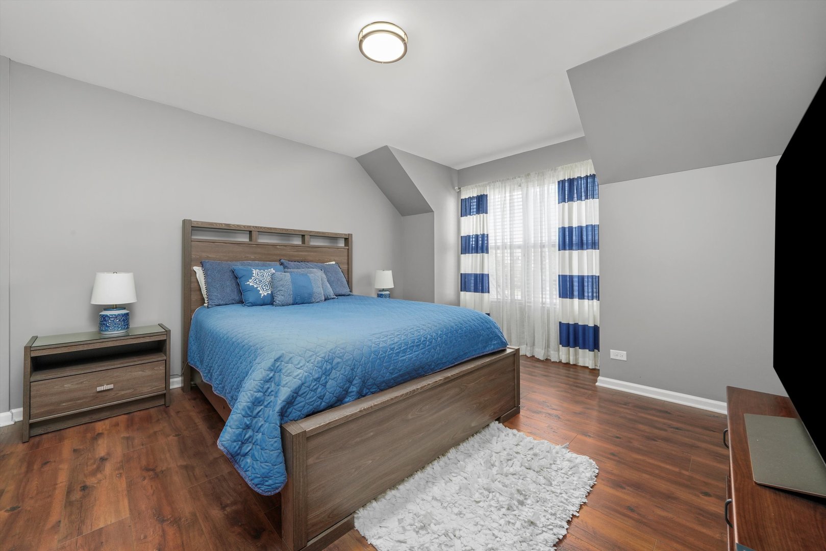 749 North Misty Ridge Drive Romeoville, IL 60446 - Photo 11 of 44 a bedroom with a bed and wooden floor