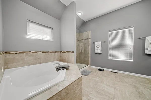 a bathroom with a bathtub and a shower