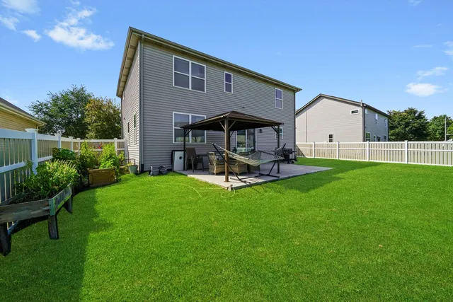 a view of a house with backyard and porch