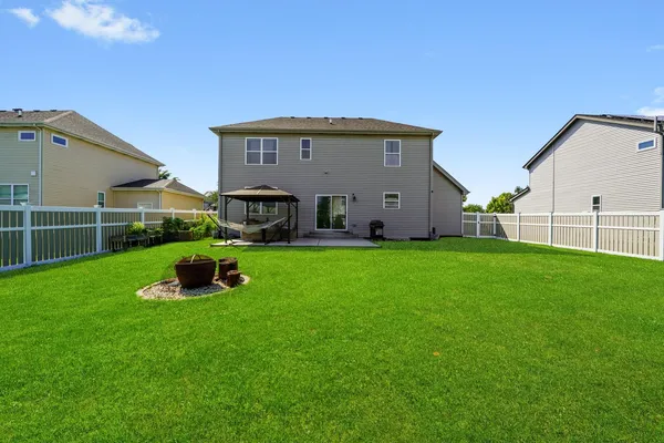 a view of a house with backyard and porch