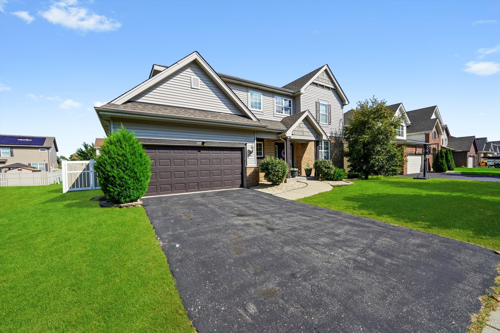 749 North Misty Ridge Drive Romeoville, IL 60446 - Photo 34 of 44 a front view of a house with a yard and garage
