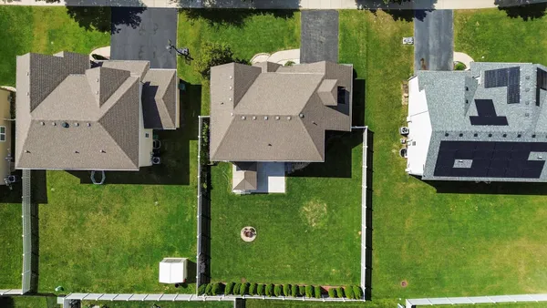 an aerial view of a house with a garden and trees