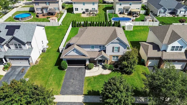 an aerial view of a house with a garden and trees