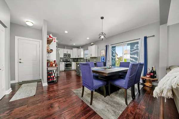 a view of a dining room with furniture and wooden floor