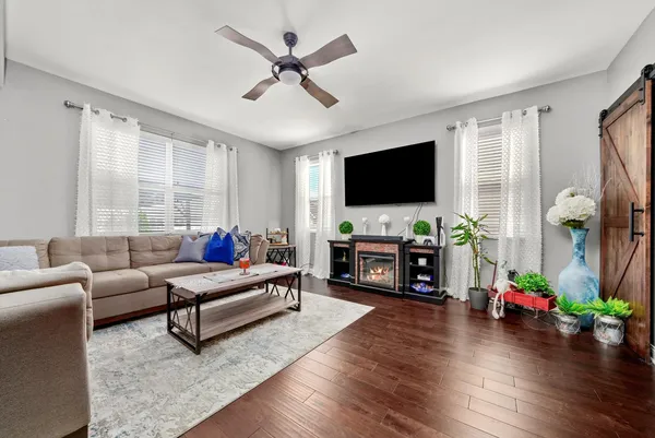 a living room with furniture a fireplace and a flat screen tv