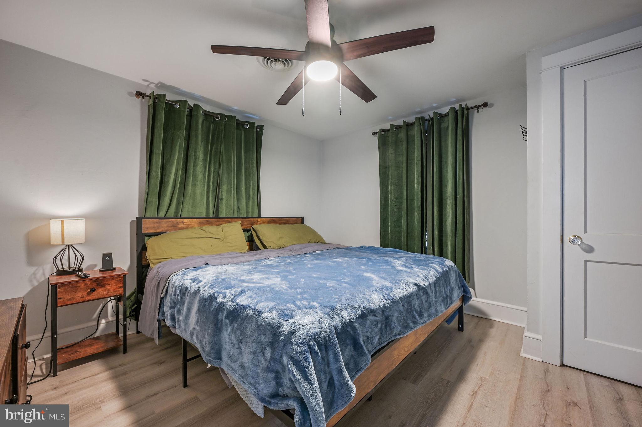 1014 White Oak Road Dover, DE 19901 - Photo 11 of 17 a bedroom with a bed and a chandelier