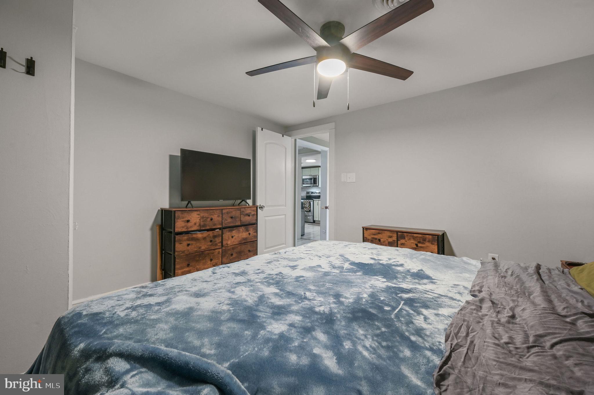 1014 White Oak Road Dover, DE 19901 - Photo 12 of 17 a bedroom with a bed and a flat screen tv