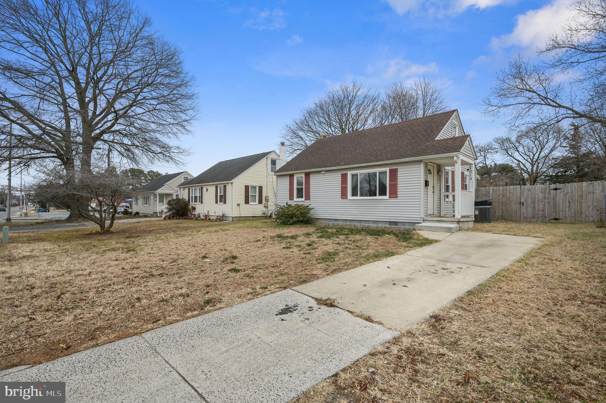 1014 White Oak Road Dover, DE 19901 - Photo 2 of 17 a front view of a house with a yard covered with snow