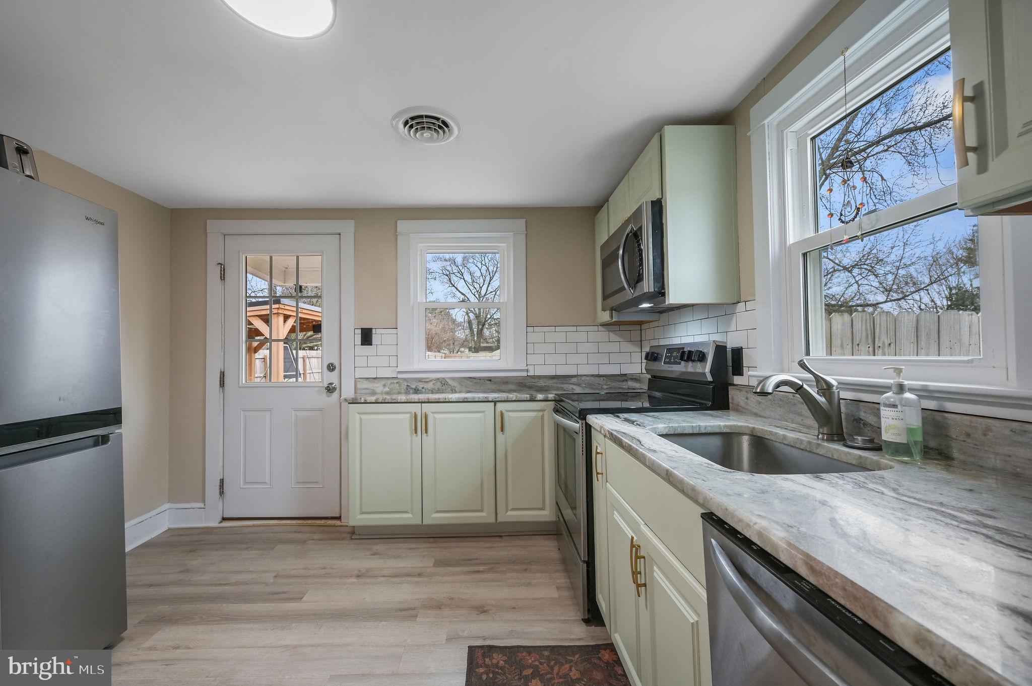 1014 White Oak Road Dover, DE 19901 - Photo 7 of 17 a kitchen with a sink cabinets and window