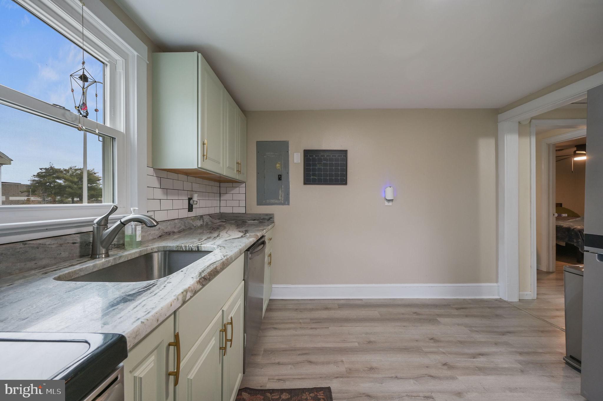 1014 White Oak Road Dover, DE 19901 - Photo 9 of 17 a kitchen with a sink cabinets and a wooden floor