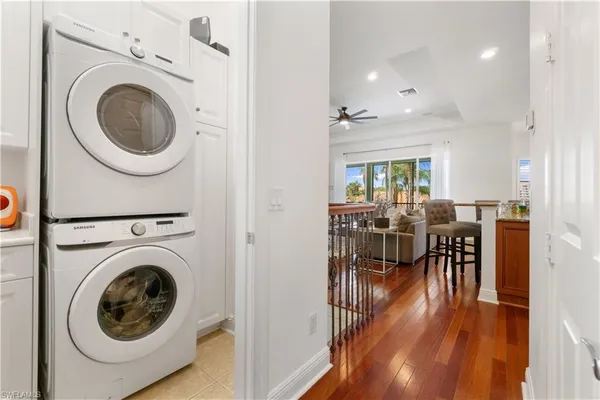 a view of a a dining room with furniture a rug and wooden floor