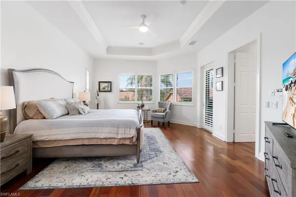 a spacious bedroom with a bed a table and chair