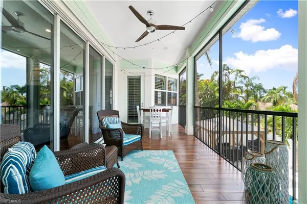 a living room with furniture a wooden floor and a chandelier