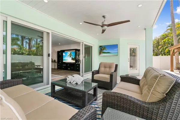 a swimming pool with outdoor seating and barbeque oven
