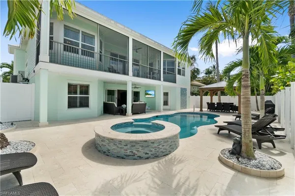 a view of a house with swimming pool and porch