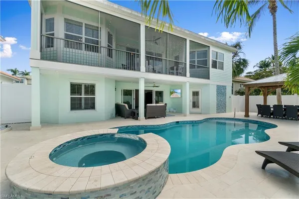 a view of a patio with swimming pool table and chairs