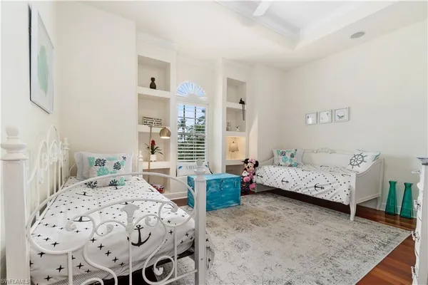 a living room with furniture wooden floor and a large window