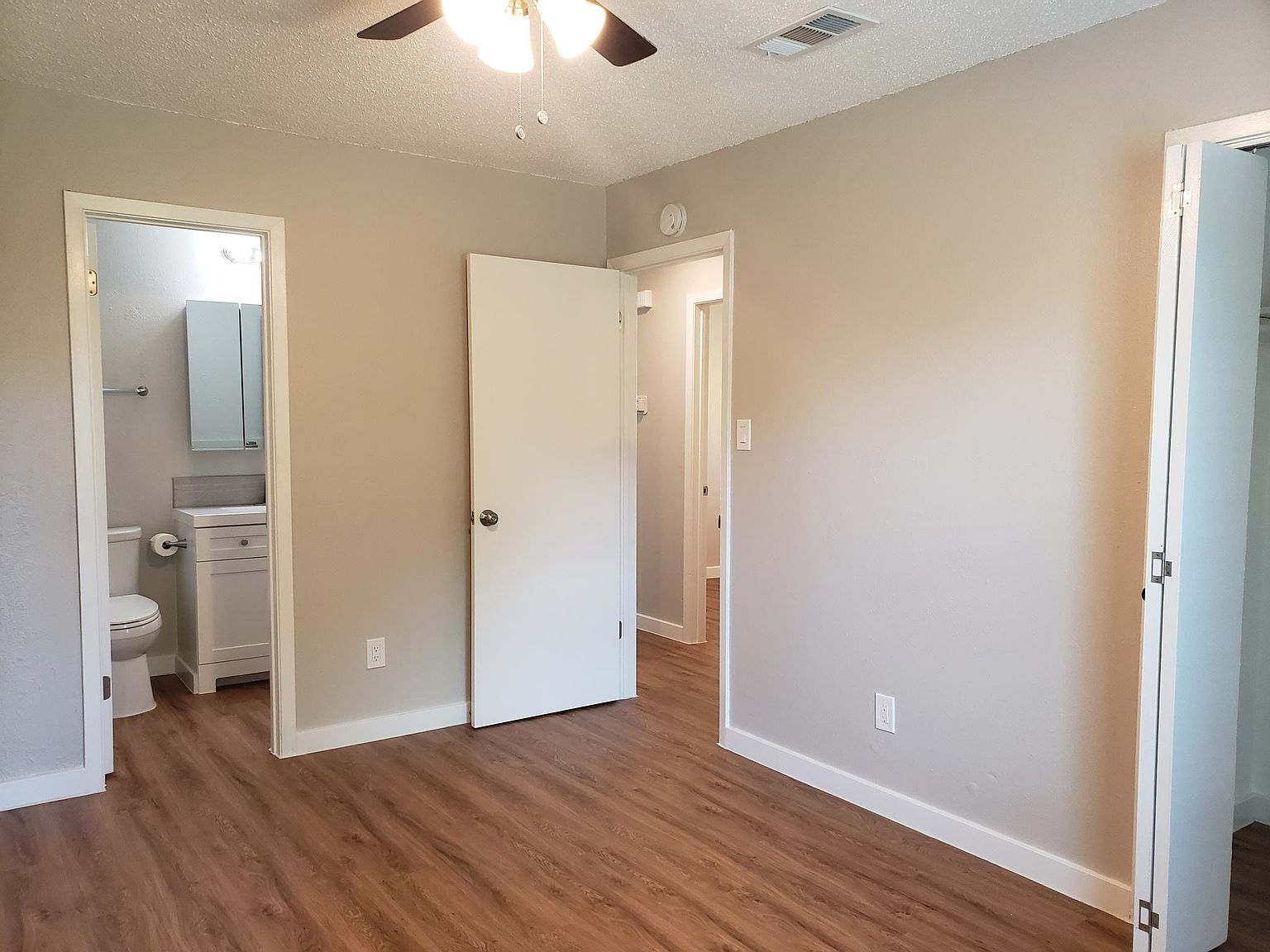 802 Ranch Road, Unit A Georgetown, TX 78628 - Photo 7 of 11 Hardwood-style flooring and a ceiling fan create a comfortable and modern living space.