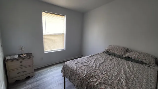 a bedroom with a bed and a window