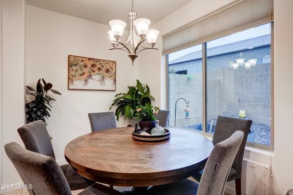 a view of a dining room with furniture wooden floor and chandelier