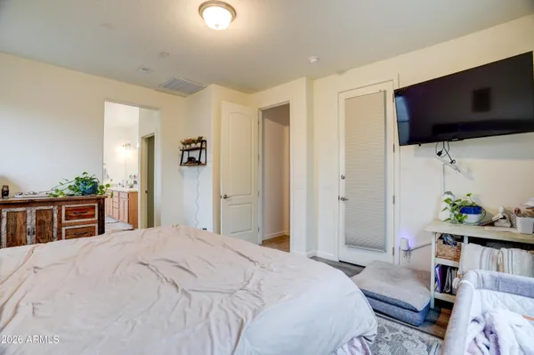 a bedroom with a bed and flat screen tv