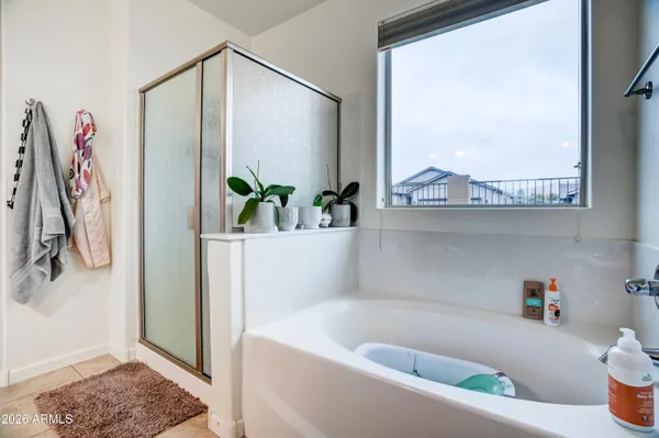 a bathroom with a bathtub and a window
