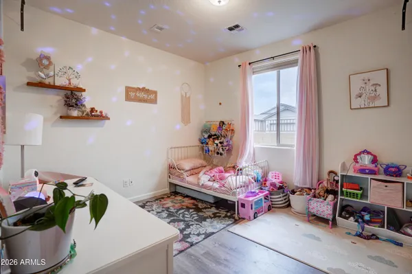 a bedroom with furniture toys and a potted plant