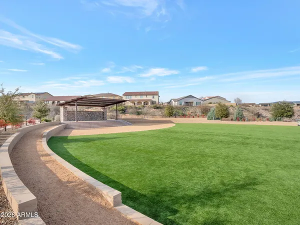 a view of a grassy field with ocean view