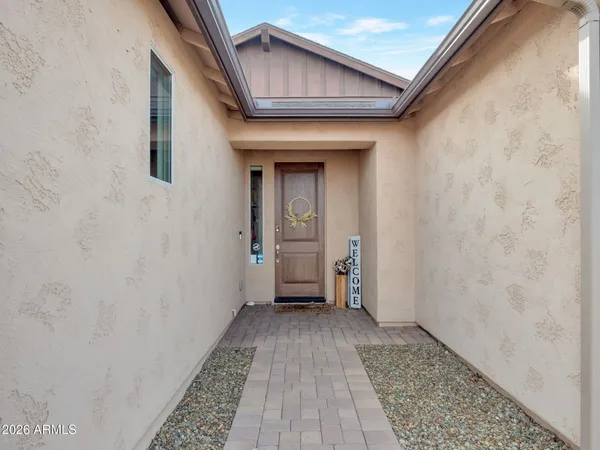 a view of a hallway with wooden floor and a door