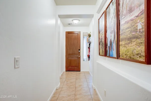 a view of a hallway with wooden shelves