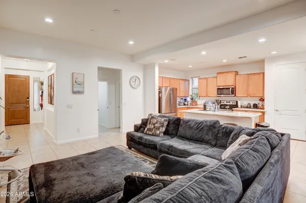 a living room with a couch and a view of kitchen