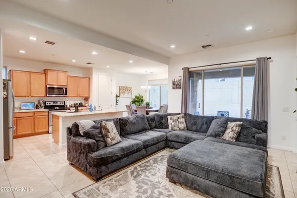 a living room with furniture and kitchen view