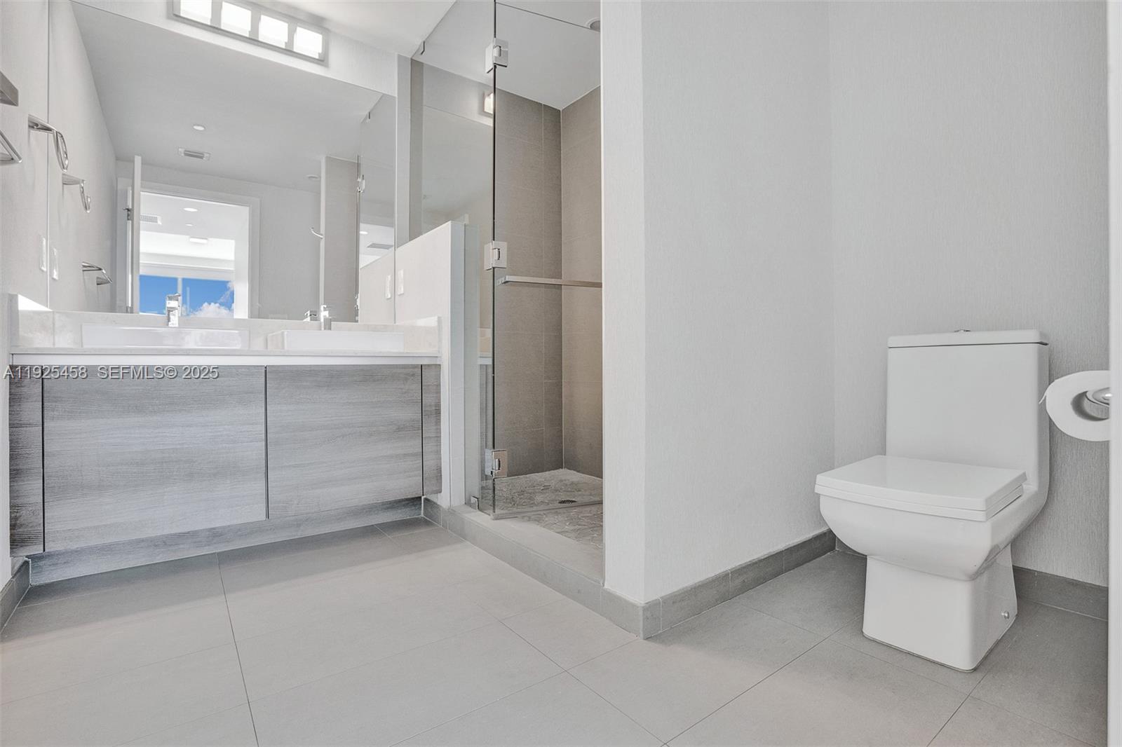 1080 Brickell Avenue, Unit 4109 Miami, FL 33131 - Photo 13 of 23 a bathroom with a toilet sink and shower