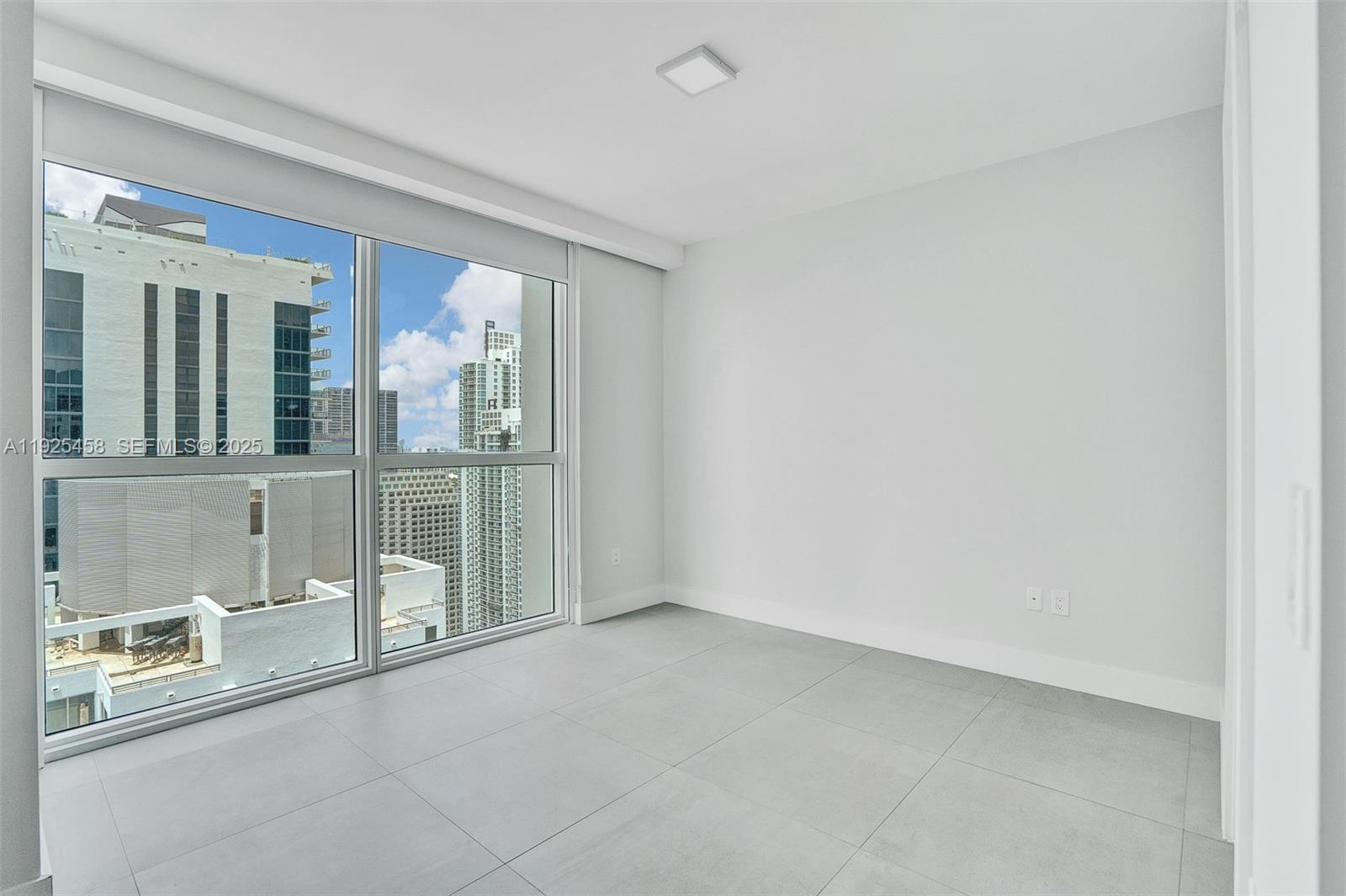 1080 Brickell Avenue, Unit 4109 Miami, FL 33131 - Photo 18 of 23 a view of an empty room with glass door