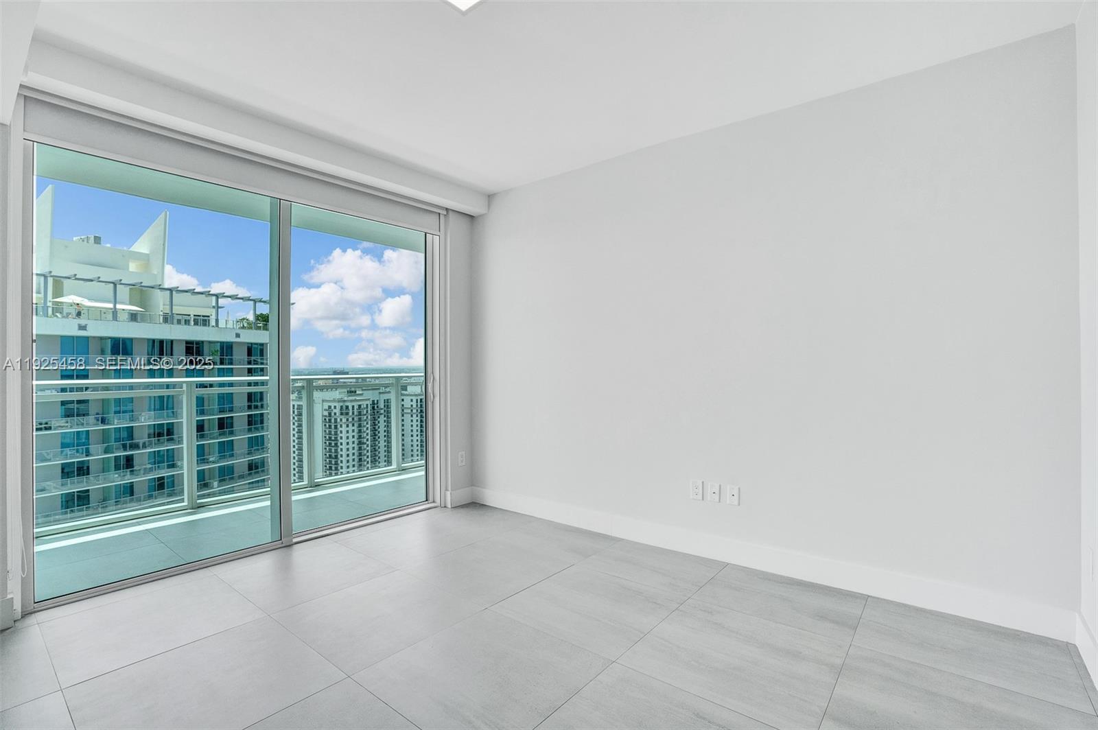 1080 Brickell Avenue, Unit 4109 Miami, FL 33131 - Photo 8 of 23 a view of an empty room with a sliding door
