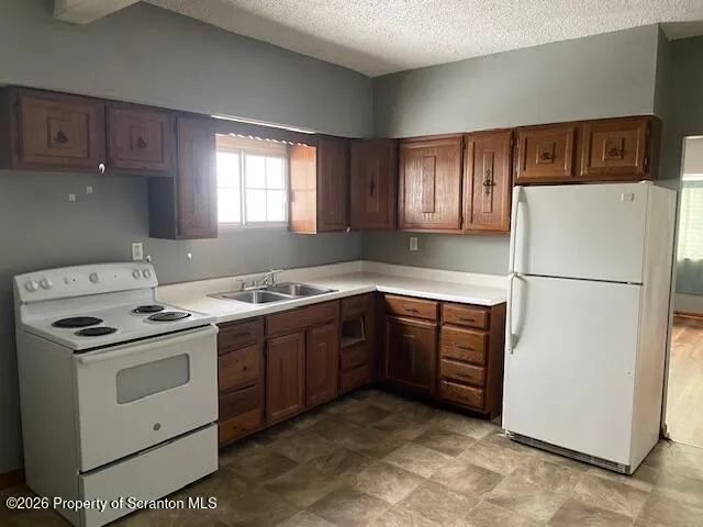 a kitchen with a stove sink and refrigerator