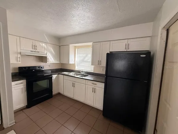 a kitchen with a refrigerator stove and sink