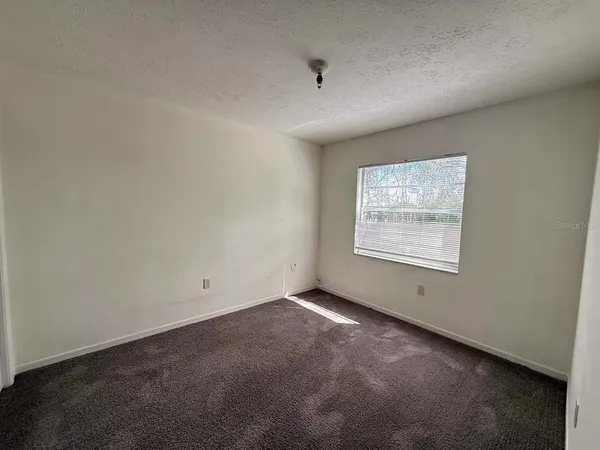 an empty room with a empty space and windows