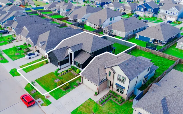 an aerial view of multiple houses with yard
